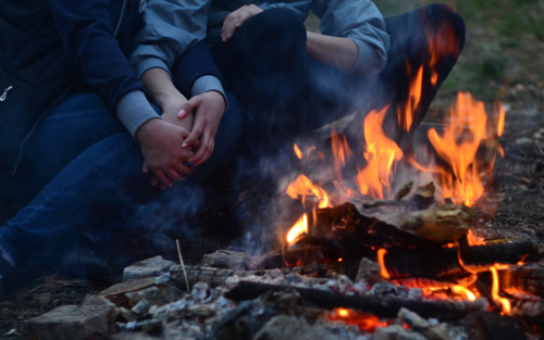 Fall outdoor activities couple by bonfire Athens Ga