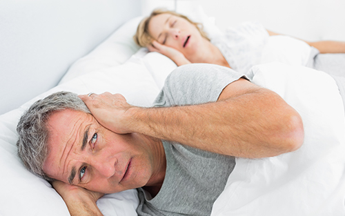 A symptom of sleep apnea is snoring